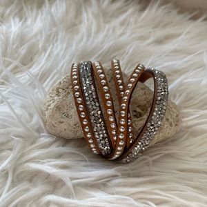 Light brown bracelet with silver buttons.